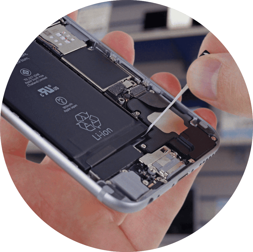 An opened phone held in one hand with the lithium battery visible inside the frame