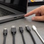 USB-A USB-C and Thunderbolt-style connectors beside a laptop