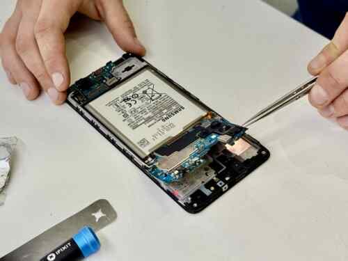 Fixfactor Samsung Phone Motherboard Removing on White Surface