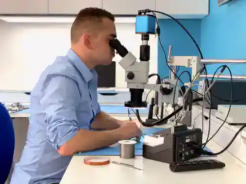 Fixfactor Technician Uses Microscope For Microsoldering Job
