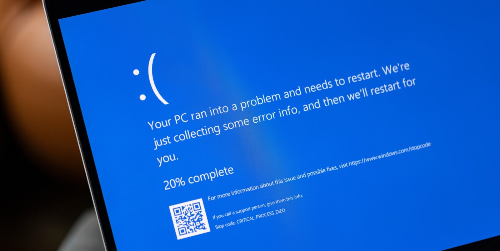 Laptop screen showing a Windows 11 blue screen error with the stop code CRITICAL_PROCESS_DIED