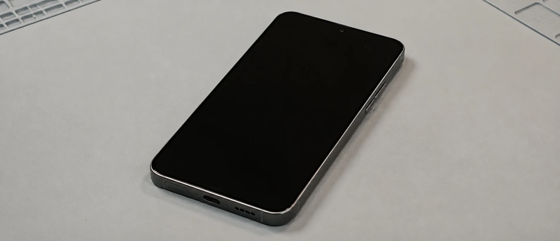 Illustration of a Galaxy phone with a black screen on a work surface